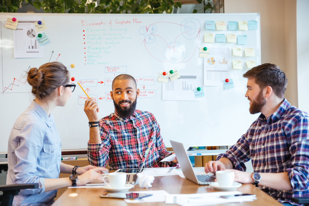 Multiethnic group of young people sitting in conference room and brainstorming on business meeting-1 Multiethnic group of young people sitting in conference room and brainstorming on business meeting-1